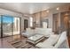 Spacious living room with hardwood floors and a sliding door leading to a balcony, offers indoor-outdoor living at 180 N Cook St # 509, Denver, CO 80206