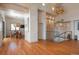 Open-concept living room and dining area with unique lighting fixtures and lots of space at 180 N Cook St # 509, Denver, CO 80206