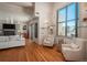 Cozy living room featuring a fireplace, comfortable seating, and a large window with city views at 180 N Cook St # 509, Denver, CO 80206