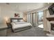 Bright main bedroom featuring natural light, a fireplace, and access to the terrace at 180 N Cook St # 509, Denver, CO 80206