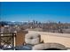 City skyline view from balcony with snow-capped mountains in the distance at 180 N Cook St # 509, Denver, CO 80206