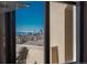 Through the window, a stunning view of the city skyline and snow-capped mountains beyond at 180 N Cook St # 509, Denver, CO 80206
