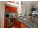 Modern wet bar boasts wine fridge, counter seating, and stylish backsplash, perfect for entertaining guests at 180 N Cook St # 509, Denver, CO 80206