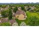 Drone shot showcasing an updated multi-Gathering home with mature trees and lush lawns at 10349 W Fair Ave # A, Littleton, CO 80127