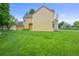 A wide-angle shot of a large, well-maintained lawn that leads up to a multi-Gathering home at 10349 W Fair Ave # A, Littleton, CO 80127