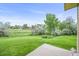 View of the home's green backyard and trees from the patio at 10349 W Fair Ave # A, Littleton, CO 80127