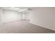 A sprawling carpeted basement with updated lighting and a neutral color scheme at 10349 W Fair Ave # A, Littleton, CO 80127