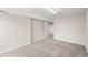 Open view of a large basement featuring neutral colors and carpeted floors at 10349 W Fair Ave # A, Littleton, CO 80127