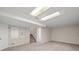 Large, carpeted basement with finished ceilings and access to the upper floors via carpeted stairs at 10349 W Fair Ave # A, Littleton, CO 80127