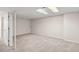 Spacious carpeted basement featuring a large open floorplan and drop ceiling with bright lighting at 10349 W Fair Ave # A, Littleton, CO 80127