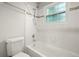Bathroom with white subway tile, a shower-tub combo, and a chrome shower head at 10349 W Fair Ave # A, Littleton, CO 80127