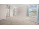Bedroom with neutral carpet, light walls, closet, and ensuite bathroom with natural light at 10349 W Fair Ave # A, Littleton, CO 80127