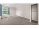 Bedroom with neutral carpet, light walls, closet, and natural light from a window at 10349 W Fair Ave # A, Littleton, CO 80127