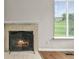 Living room detail of tiled fireplace and view to the exterior at 10349 W Fair Ave # A, Littleton, CO 80127