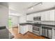 Kitchen features granite countertops, stainless steel appliances and white cabinets at 10349 W Fair Ave # A, Littleton, CO 80127