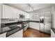 Well-lit kitchen with stainless steel appliances, granite countertops, and ample cabinet space at 10349 W Fair Ave # A, Littleton, CO 80127