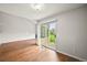 Open living area with wood floors and sliding glass doors to outdoor patio at 10349 W Fair Ave # A, Littleton, CO 80127