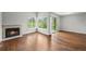 Bright living room featuring hardwood floors, a cozy fireplace, and sliding glass doors to the outside at 10349 W Fair Ave # A, Littleton, CO 80127