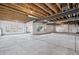 Unfinished basement with exposed beams and large windows offers potential for customization at 3976 Breakcamp Ct, Castle Rock, CO 80108