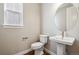 Charming powder room features a pedestal sink, toilet and window providing natural light at 3976 Breakcamp Ct, Castle Rock, CO 80108