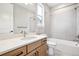 Bathroom featuring a modern vanity, mirror, toilet, and tiled bathtub with shower at 3976 Breakcamp Ct, Castle Rock, CO 80108