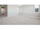 Bright bedroom features neutral paint, carpet, and trim; two windows provide natural light at 3976 Breakcamp Ct, Castle Rock, CO 80108