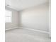 The bright bedroom features neutral paint, carpet, and trim; a large window provides natural light at 3976 Breakcamp Ct, Castle Rock, CO 80108