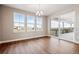 Open dining room with wood floors, modern chandelier and slider doors accessing the outdoor patio at 3976 Breakcamp Ct, Castle Rock, CO 80108