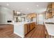 Modern kitchen features stainless steel appliances, wood cabinetry and a large island with white countertops at 3976 Breakcamp Ct, Castle Rock, CO 80108