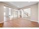 Spacious living area with stairs, glass-enclosed area, and wooden floors flooded with natural light at 3976 Breakcamp Ct, Castle Rock, CO 80108