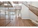 Spacious living area with stairs, glass-enclosed area, and wooden floors flooded with natural light at 3976 Breakcamp Ct, Castle Rock, CO 80108