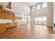 Open-concept living space with natural light, wood floors, an island kitchen, and a balcony view at 3976 Breakcamp Ct, Castle Rock, CO 80108