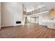 Spacious living room with wood floors, fireplace and large window, with stairs leading up to the second floor at 3976 Breakcamp Ct, Castle Rock, CO 80108