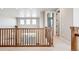 A large, bright loft, featuring a wooden banister overlooking the floor below at 3976 Breakcamp Ct, Castle Rock, CO 80108