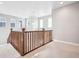 Cozy loft space with carpeted flooring, wooden railing, and multiple windows providing natural light at 3976 Breakcamp Ct, Castle Rock, CO 80108
