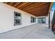 Spacious concrete patio featuring an unfinished wood ceiling and glass sliding doors at 3976 Breakcamp Ct, Castle Rock, CO 80108