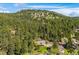 Charming home nestled amidst trees, providing privacy and scenic mountain views at 7284 Willa Ln, Evergreen, CO 80439
