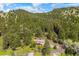 Secluded home surrounded by lush forest offers a peaceful retreat in a natural setting at 7284 Willa Ln, Evergreen, CO 80439