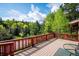 Enjoy the scenic views from this spacious wooden deck with a classic wood railing at 7284 Willa Ln, Evergreen, CO 80439
