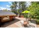 Spacious deck with BBQ grill overlooks the backyard, perfect for enjoying outdoor meals in a wooded setting at 7284 Willa Ln, Evergreen, CO 80439
