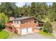 Two-story house features attached garage, private deck, wood siding and is surrounded by a picturesque, wooded landscape at 7284 Willa Ln, Evergreen, CO 80439
