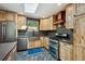 Contemporary kitchen with custom wood cabinets, stainless steel appliances, copper sink and stylish backsplash at 7284 Willa Ln, Evergreen, CO 80439