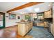 Modern kitchen featuring custom cabinetry, stone countertops, stainless steel appliances, and skylight at 7284 Willa Ln, Evergreen, CO 80439