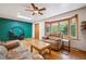 Bright living room with hardwood floors, stylish furniture, and a large bay window at 7284 Willa Ln, Evergreen, CO 80439