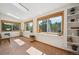 Bright sunroom filled with natural light, windows and tiled floor at 7284 Willa Ln, Evergreen, CO 80439
