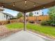 Enjoy the outdoors on the covered patio, overlooking the landscaped backyard and wooden fence at 3838 Brush Rd, Castle Rock, CO 80108