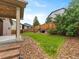 Charming backyard featuring a lush lawn, rock landscape, and a covered patio, great for entertaining at 3838 Brush Rd, Castle Rock, CO 80108