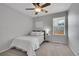 Cozy bedroom with a ceiling fan, neutral carpet, and a bright window illuminating the space at 3838 Brush Rd, Castle Rock, CO 80108