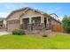 Single story home showcasing stone columns, covered porch, and lush lawn at 3838 Brush Rd, Castle Rock, CO 80108