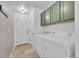 Functional laundry room with washer, dryer, green cabinets, and a tile floor at 3838 Brush Rd, Castle Rock, CO 80108